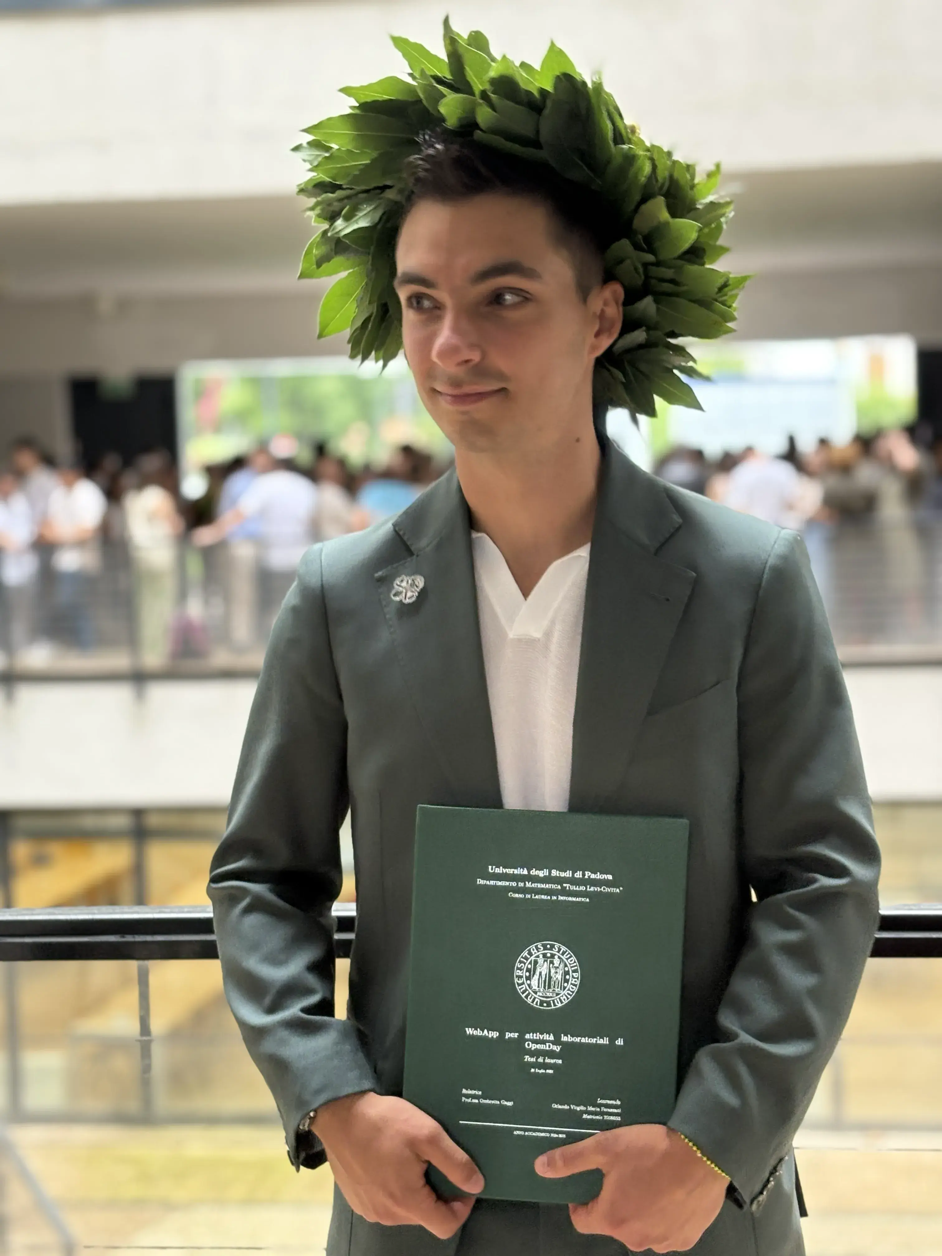 Orlando on graduation day, wearing a laurel wreath and holding his degree